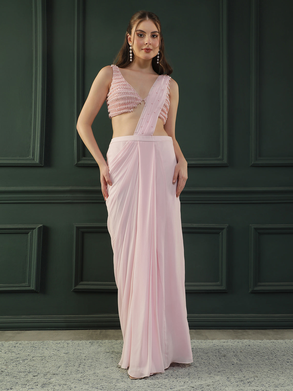 Powder Pink pre-drape georgette saree paired beautifully with a hand-embellished pink pearl blouse.