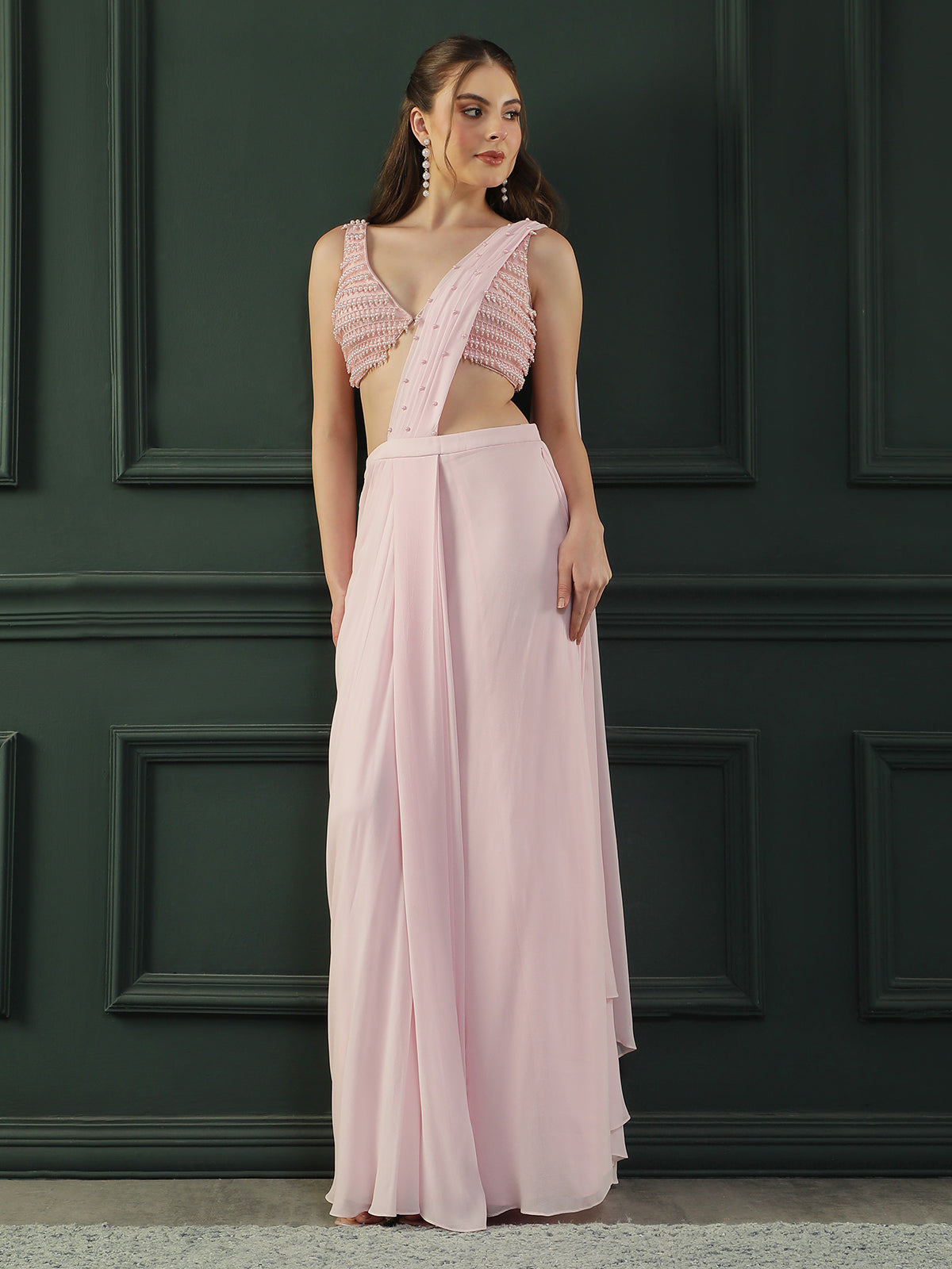 Powder Pink pre-drape georgette saree paired beautifully with a hand-embellished pink pearl blouse.