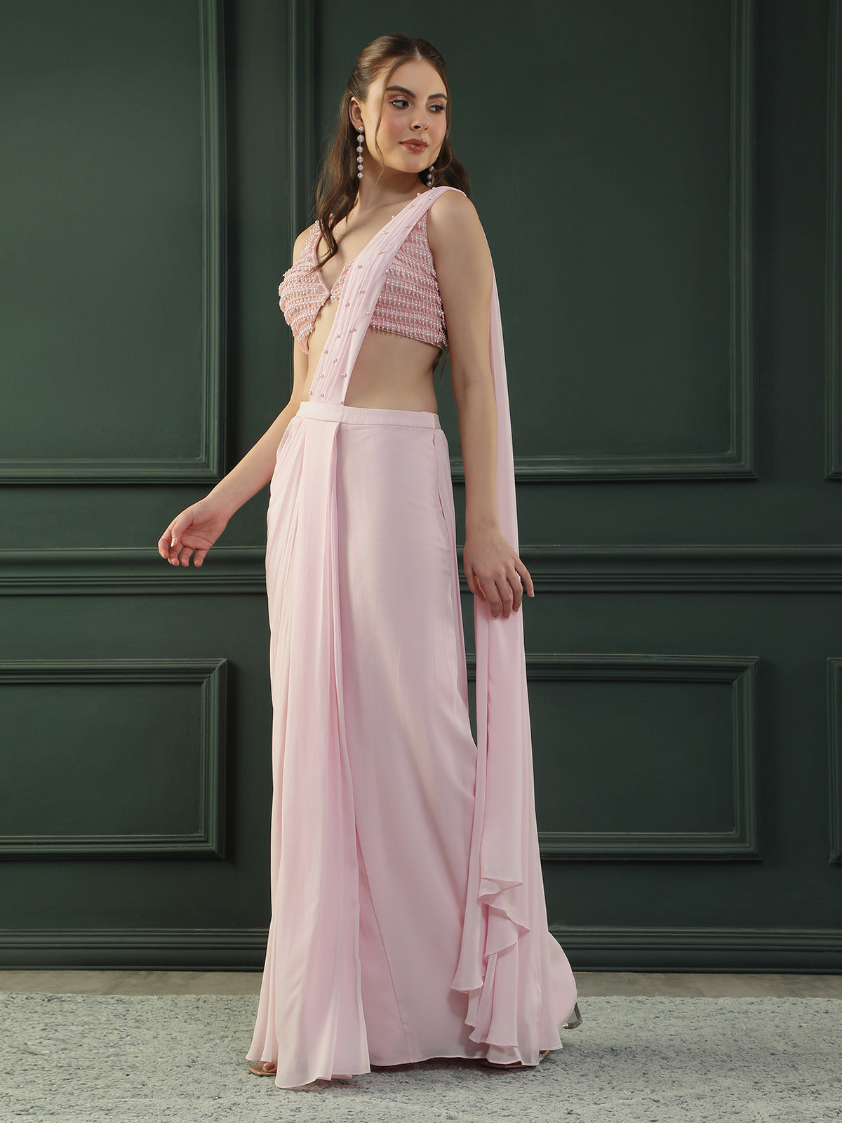 Powder Pink pre-drape georgette saree paired beautifully with a hand-embellished pink pearl blouse.
