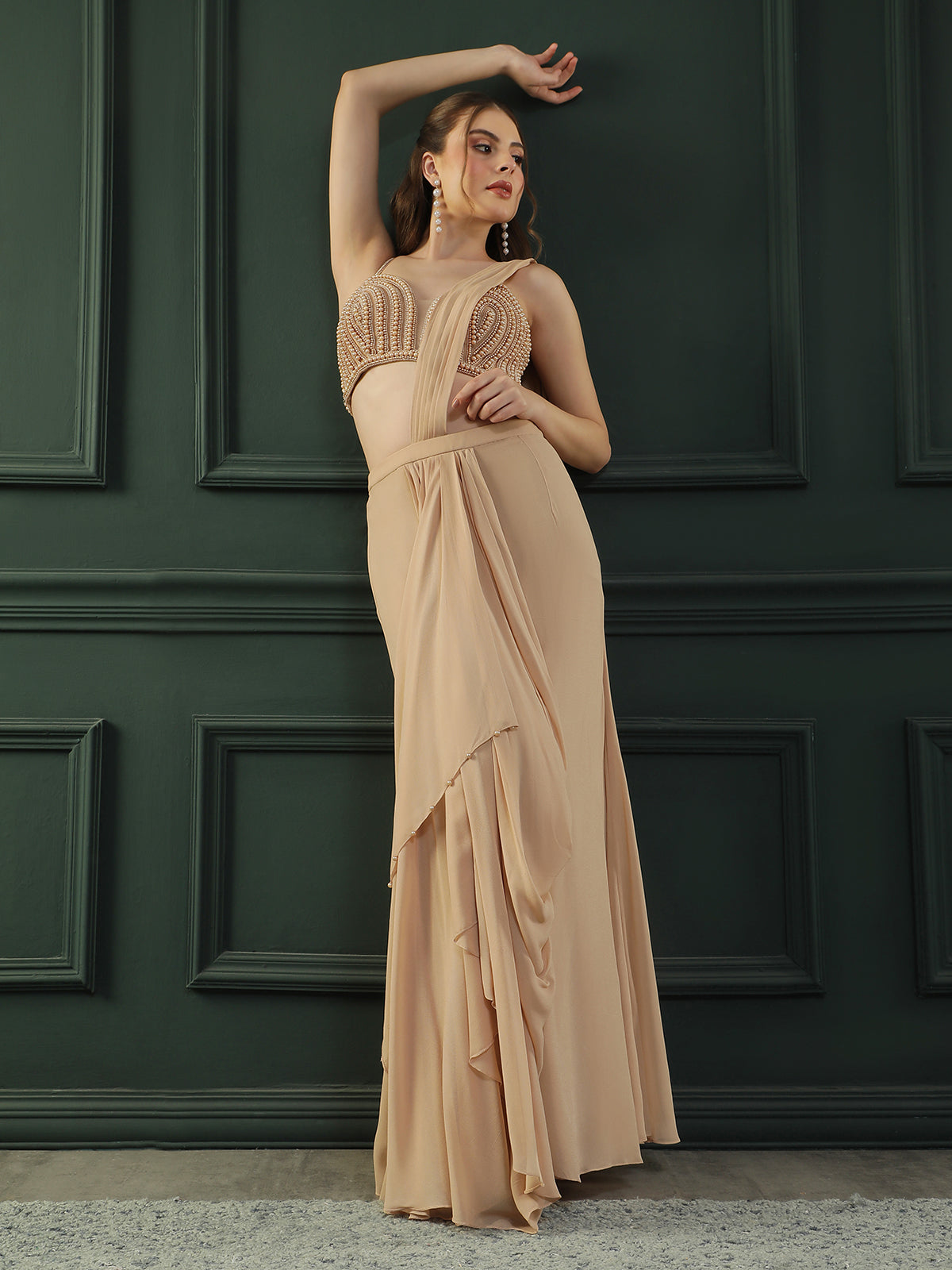 Tan Brown pre-drape georgette saree paired beautifully with a hand-embellished pearl blouse.