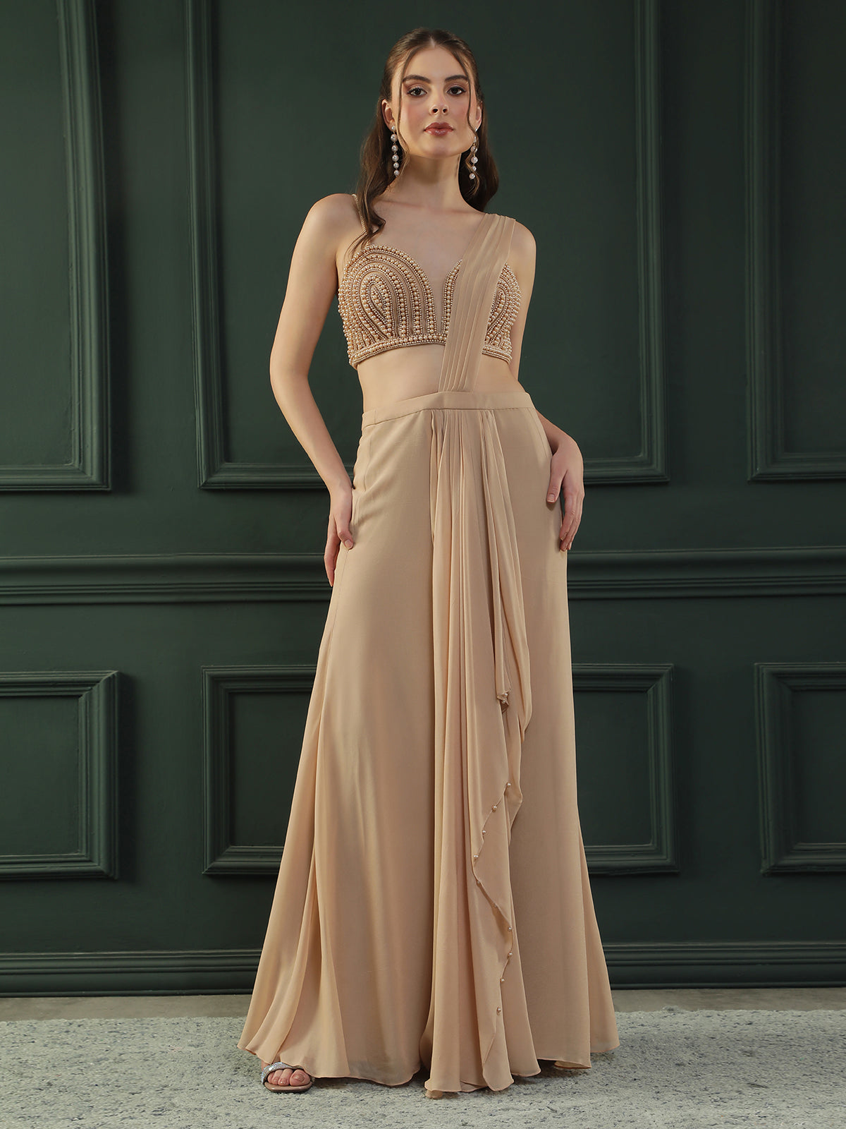 Tan Brown pre-drape georgette saree paired beautifully with a hand-embellished pearl blouse.
