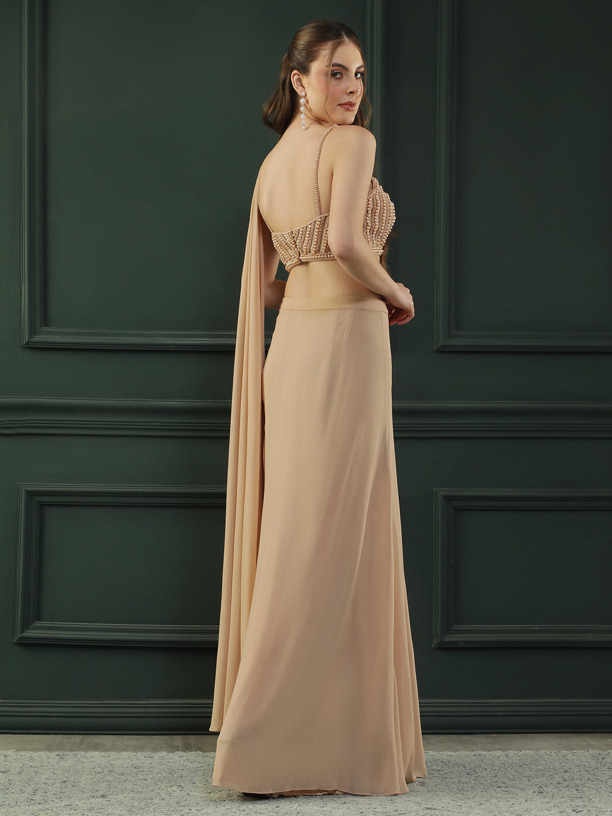 Tan Brown pre-drape georgette saree paired beautifully with a hand-embellished pearl blouse.