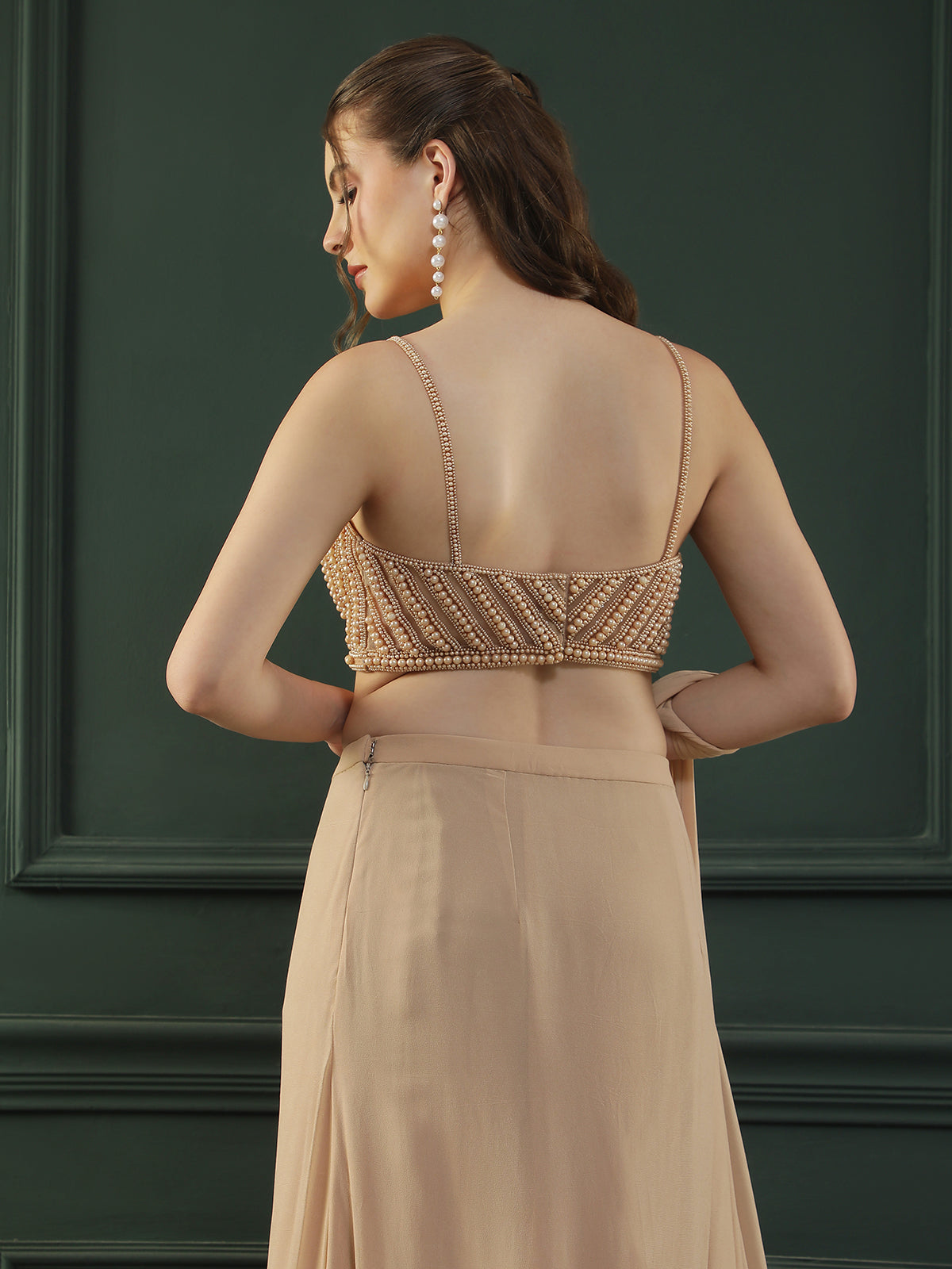 Tan Brown pre-drape georgette saree paired beautifully with a hand-embellished pearl blouse.