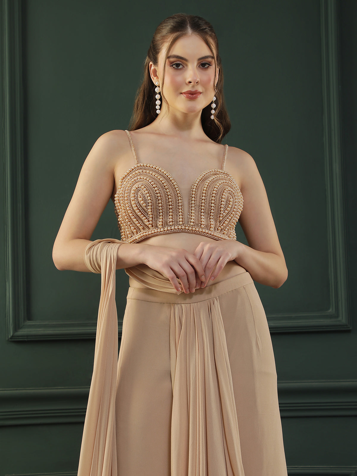 Tan Brown pre-drape georgette saree paired beautifully with a hand-embellished pearl blouse.