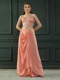 Peach drape skirt paired with brocade corset with a hand-embellished pearl highlight and plain dupatta with latkans drop on its sides.