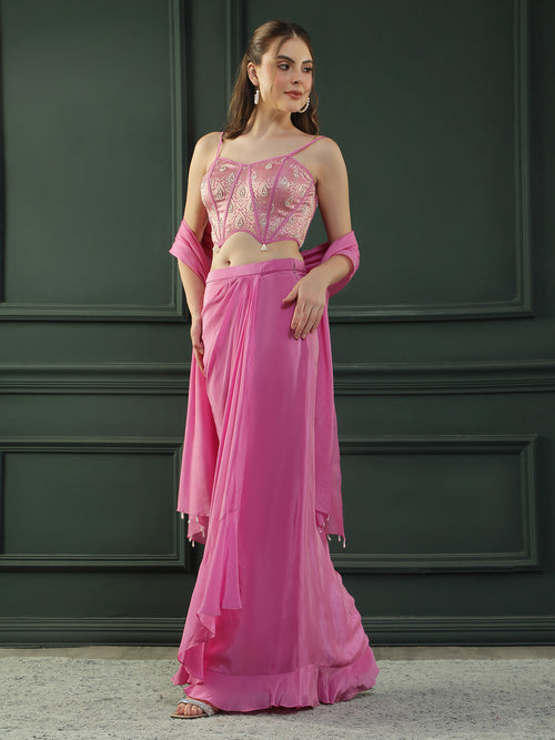 Fuscia Pink crepe drape skirt paired with brocade corset with a hand-embellished pearl highlight and plain dupatta with latkans drop on its sides.