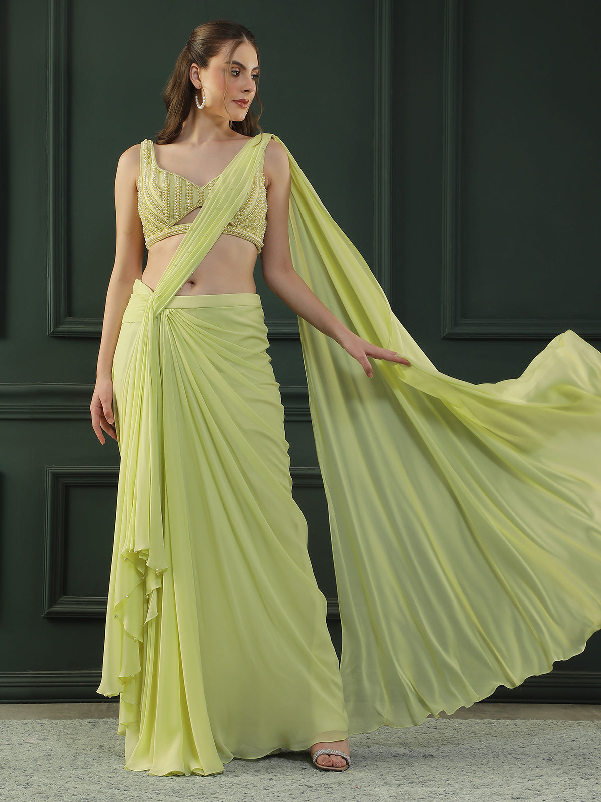 Lime-green pre-drape georgette saree paired beautifully with a hand-embellished pearl blouse.