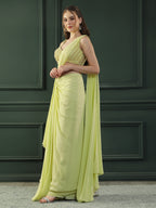 Lime-green pre-drape georgette saree paired beautifully with a hand-embellished pearl blouse.