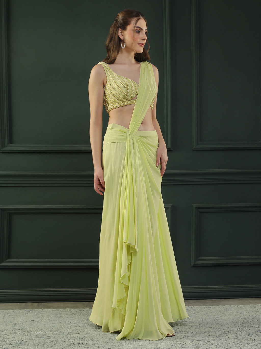 Lime-green pre-drape georgette saree paired beautifully with a hand-embellished pearl blouse.