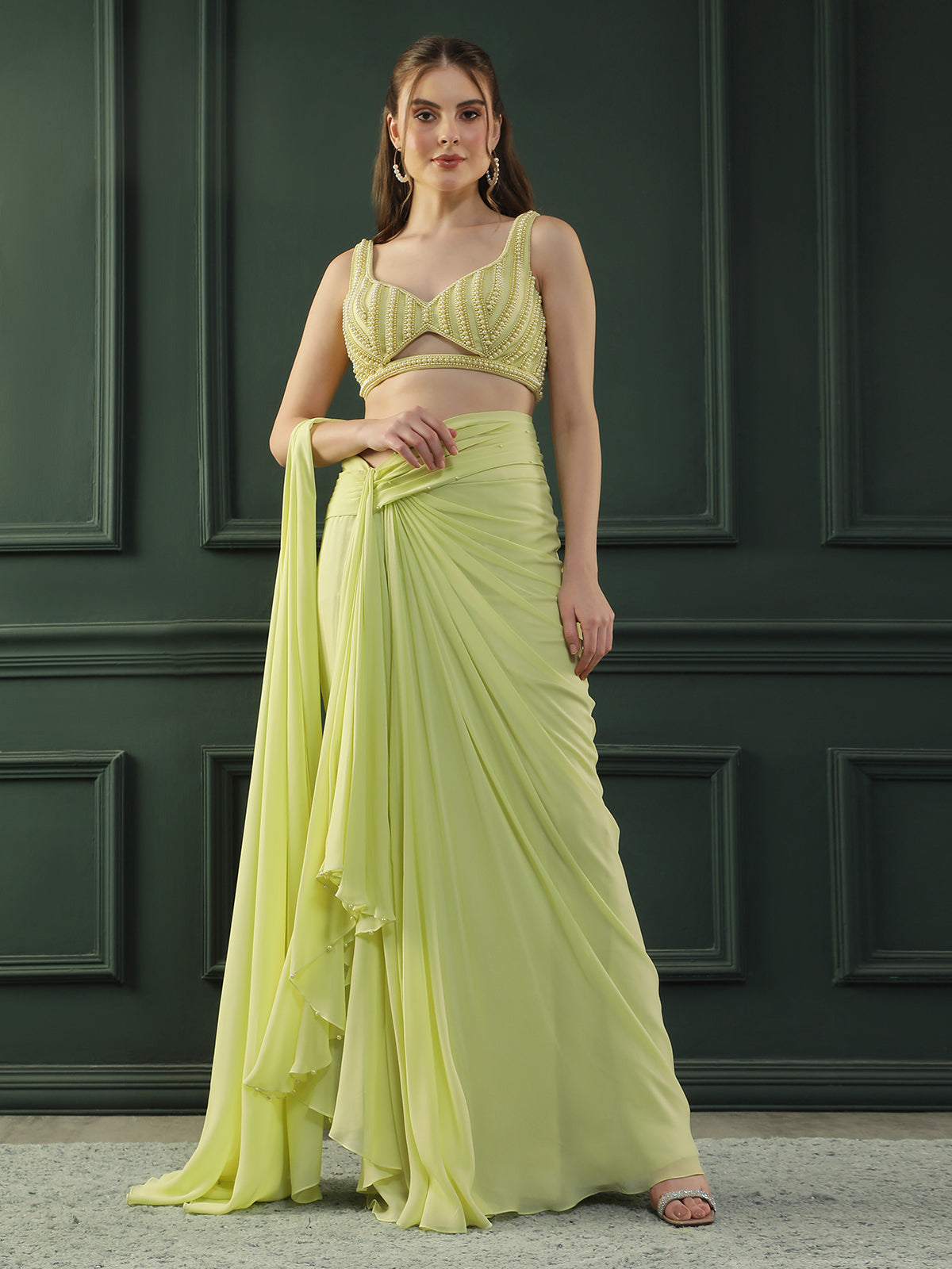 Lime-green pre-drape georgette saree paired beautifully with a hand-embellished pearl blouse.