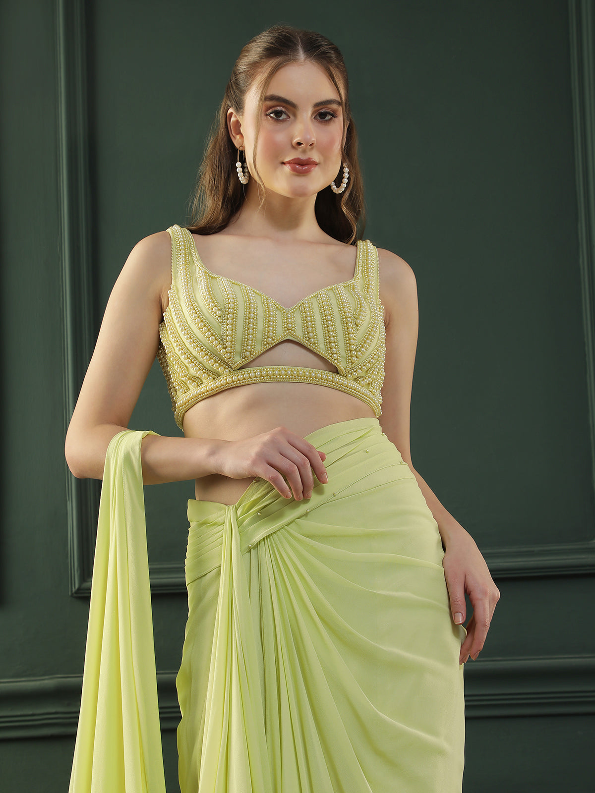 Lime-green pre-drape georgette saree paired beautifully with a hand-embellished pearl blouse.