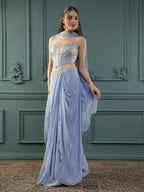 Lilac drape skirt paired with brocade corset with a hand-embellished pearl highlight and plain dupatta with latkans drop on its sides.