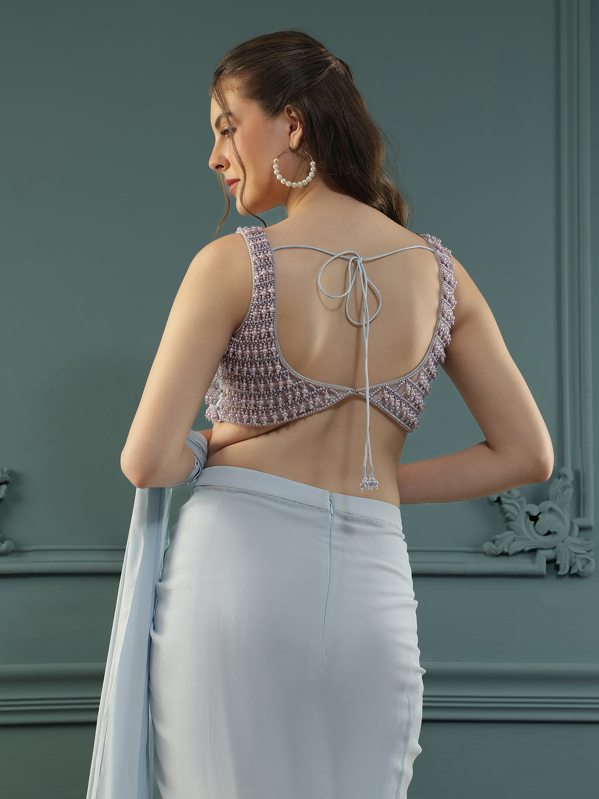 Powder Blue pre-drape georgette saree paired beautifully with a hand-embellished pearl blouse.