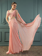 Peach pre-drape georgette saree paired beautifully with a hand-embellished pearl blouse.