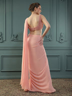 Peach pre-drape georgette saree paired beautifully with a hand-embellished pearl blouse.