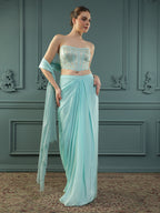 Ice-Blue drape skirt paired with brocade corset with a hand-embellished pearl highlight and plain dupatta with latkans drop on its sides.