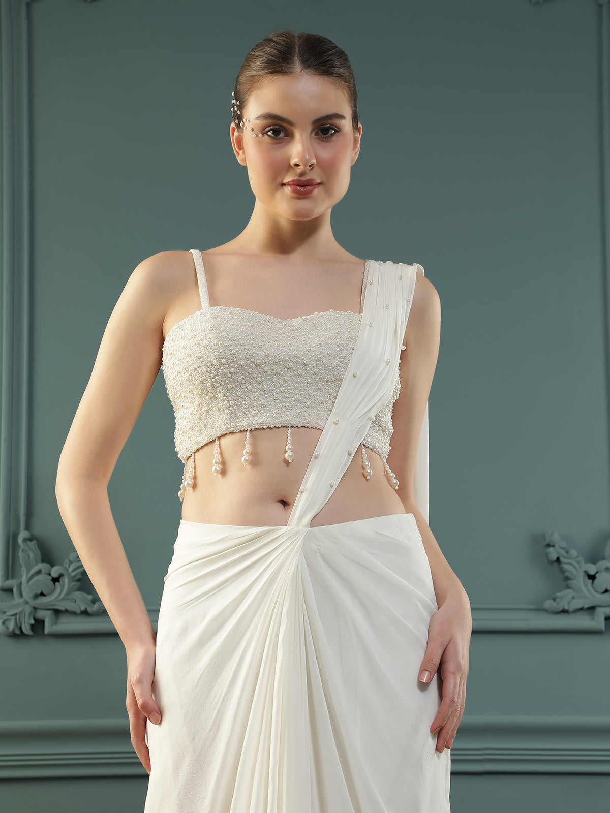 Pearl White pre-drape saree paired with a pearl-encrusted blouse.